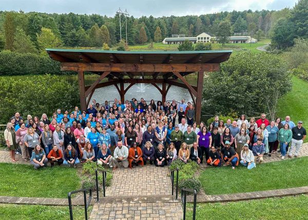 Corporate group celebrates a successful retreat at FEC with a group photo by the pond