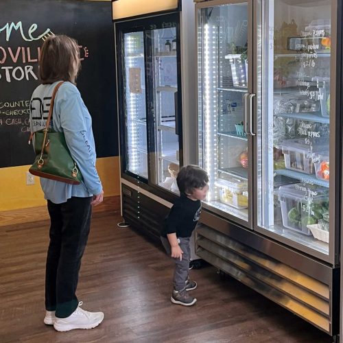 Local shoppers inspecting fresh food at the Farm Store